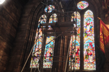 Scaffolding inside Bangor Cathedral providing access to a stained glass window.
