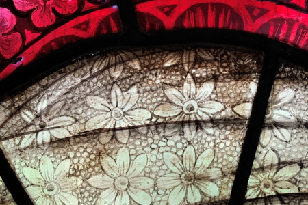 Detailed close-up of the paintwork on Mary's veil in the Nativity window.