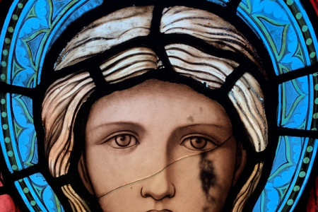 Close-up from the East window of the face of one of the heavenly hosts. The issues encountered are cracks, paint loss and guano stains on the outside.